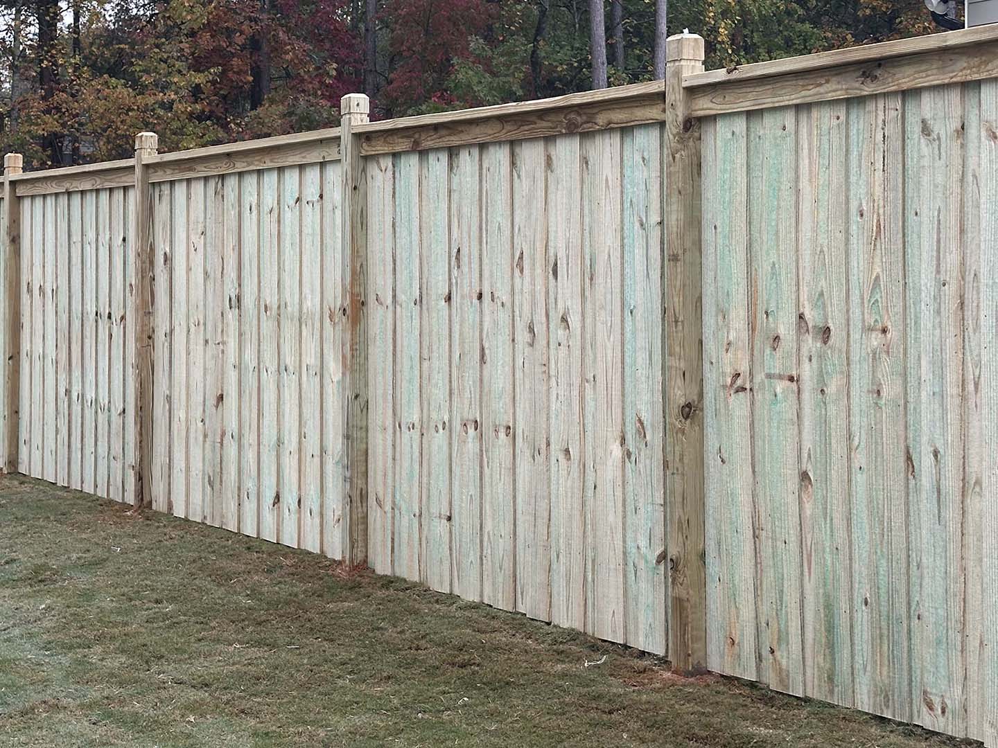 Wood privacy fence installation in North Georgia backyard