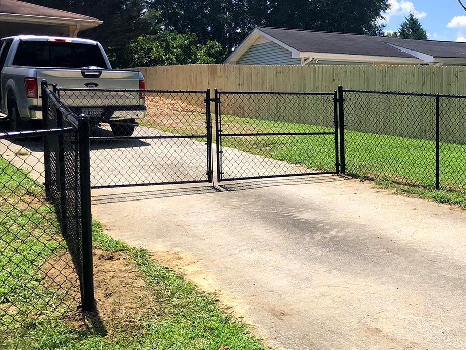Residential gate installation paired with fence in Temple GA
